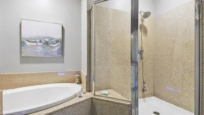 a bathroom with a bath tub and a shower at Penthouse at Laketown Wharf in PCB! 2132 in Panama City Beach