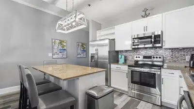 a kitchen with white cabinets and a counter top at Penthouse at Laketown Wharf in PCB! 2132 in Panama City Beach