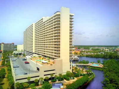 a large white building next to a river at Penthouse at Laketown Wharf in PCB! 2132 in Panama City Beach