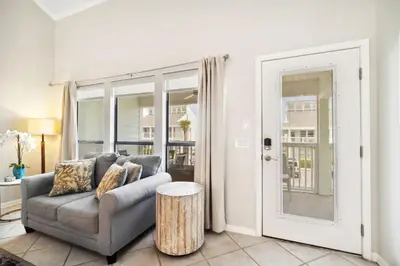 a living room with a couch and a table at Paradise found steps to beach in Panama City Beach