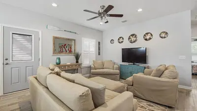 a living room with couches and a flat screen tv at PCB 3 Bed 2 Bath house Chasing Sunsets in Panama City Beach