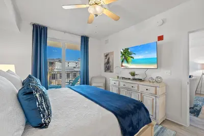 a bedroom with a bed and a ceiling fan at Calypso 3-309 - Gypsea's View in Panama City Beach