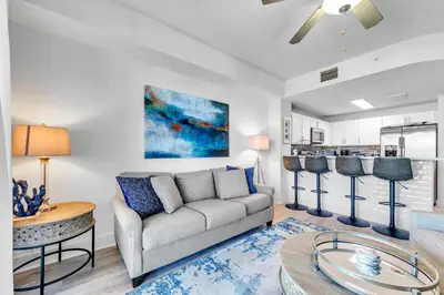 a living room with a couch and a table at Calypso 3-309 - Gypsea's View in Panama City Beach