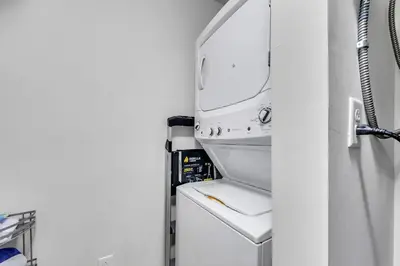 a kitchen with a sink and a mirror at Calypso 3-309 - Gypsea's View in Panama City Beach