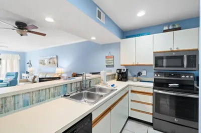 a kitchen with a sink and a microwave at Edgewater Beach View Villas #3304 in Panama City Beach