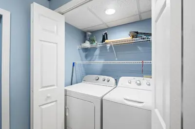 a laundry room with a washer and dryer at Edgewater Beach View Villas #3304 in Panama City Beach