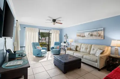 a living room with a couch and two chairs at Edgewater Beach View Villas #3304 in Panama City Beach