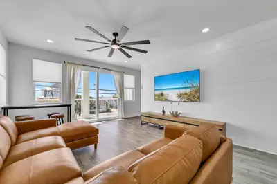 a living room with a couch and a ceiling fan at Golden Seashell East in Panama City Beach
