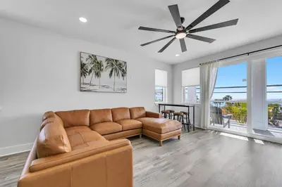 a living room with a couch and a ceiling fan at Golden Seashell East in Panama City Beach