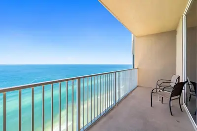 a balcony with chairs and a view of the ocean at Tidewater 2903 in Panama City Beach