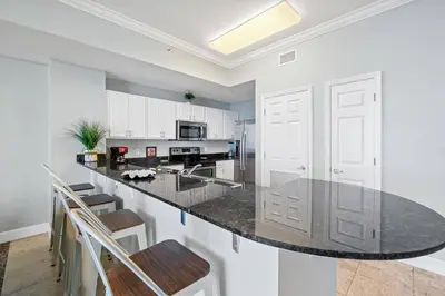 a kitchen with a black counter top in a room at Tidewater 2903 in Panama City Beach