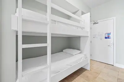 a white bunk bed in a white room at Tidewater 2903 in Panama City Beach