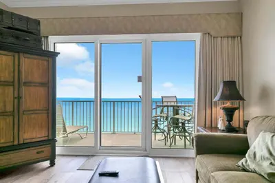 a living room with a view of the ocean at Grandview East 1604 in Panama City Beach