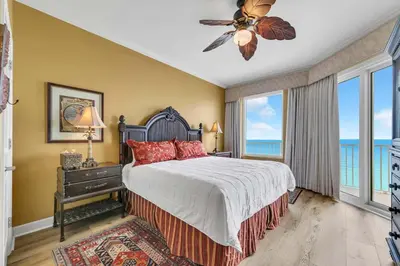 a bedroom with a bed with a view of the ocean at Grandview East 1604 in Panama City Beach