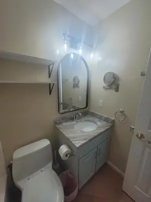 a bathroom with a toilet and a sink and a mirror at Southwinds I-5 in Panama City Beach