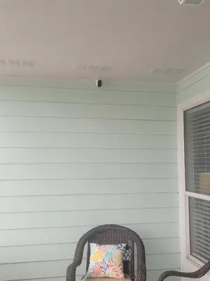 a wicker chair with a pillow on a wall at Southwinds I-5 in Panama City Beach