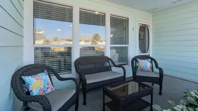 two wicker chairs and a table on a porch at Southwinds I-5 in Panama City Beach