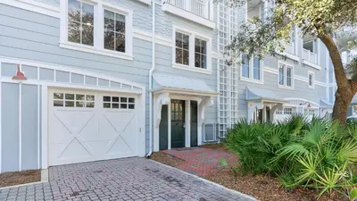 a white house with a white garage at 429 S Bridge Ln 107A in Watersound Beach