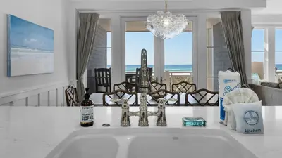 a kitchen with a sink with a view of the ocean at 429 S Bridge Ln 107A in Watersound Beach