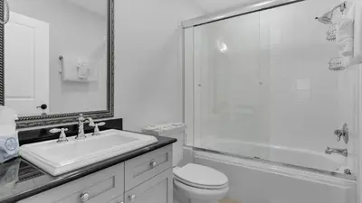 a bathroom with a sink and a toilet and a shower at 429 S Bridge Ln 107A in Watersound Beach