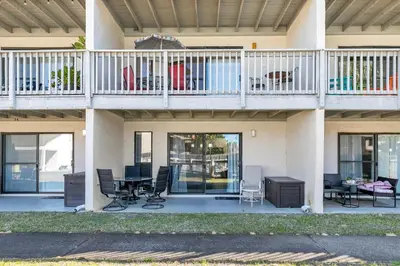 a house with a balcony with chairs and tables at Endless Summer D5 in Panama City Beach
