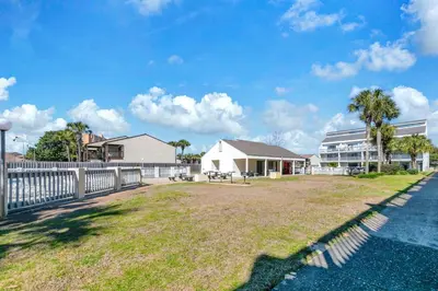 a yard with a fence and a building at Endless Summer D5 in Panama City Beach
