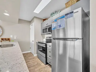 a kitchen with a stainless steel refrigerator at Edgewater Tower 3-1110 - South of Heaven in Panama City Beach