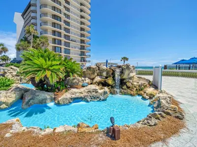 a swimming pool with a waterfall and a resort at Edgewater Tower 3-1110 - South of Heaven in Panama City Beach