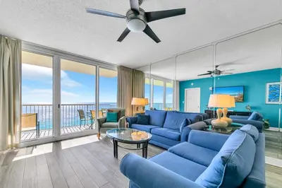 a living room with blue couches and a ceiling fan at Majestic Beach Towers 2-1801 in Panama City Beach