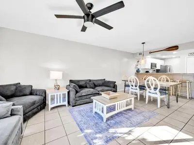 a living room with a couch and a table at Edgewater Golf Villa 3204 in Panama City Beach