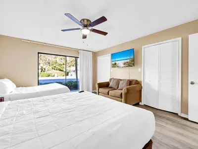 a bedroom with two beds and a ceiling fan at Edgewater Golf Villa 3204 in Panama City Beach