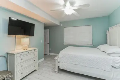 a bedroom with a bed and a flat screen tv at Fabulous Views at Emerald Beach in Panama City Beach