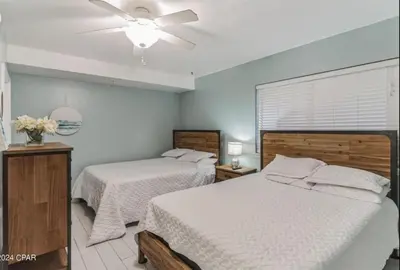a bedroom with two beds and a ceiling fan at Fabulous Views at Emerald Beach in Panama City Beach