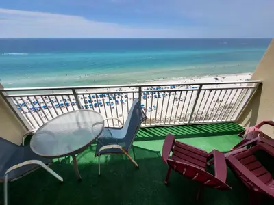 a balcony with a table and chairs and the beach at Fabulous Views at Emerald Beach in Panama City Beach