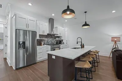 a kitchen with a stainless steel refrigerator and a counter at Serenity at Treetop in Inlet Beach