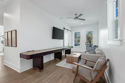 a living room with a piano and a couch at Serenity at Treetop in Inlet Beach