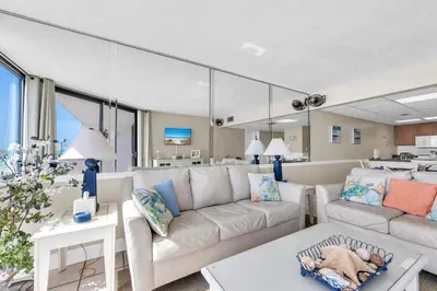 a living room with a couch and a table at Leeward 403 at Edgewater in Panama City Beach