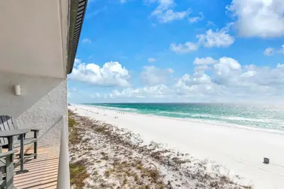 a view of the beach from the balcony of a beach house at Leeward 403 at Edgewater in Panama City Beach