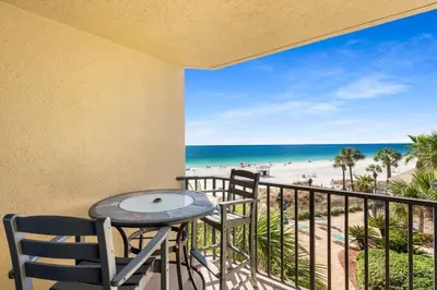 a balcony with a table and chairs and the beach at East-End PCB Condo with Gulf Views & Beach Access in Panama City Beach