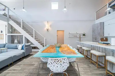a room with a table and chairs and a staircase at Private Beach, Heated Pool, Gulf Beach Front in Panama City Beach