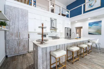 a kitchen with a large island with stools at Private Beach, Heated Pool, Gulf Beach Front in Panama City Beach