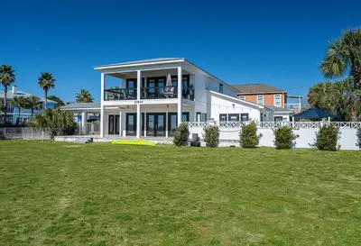 a large white house with a frisbee in front of it at Private Beach, Heated Pool, Gulf Beach Front in Panama City Beach
