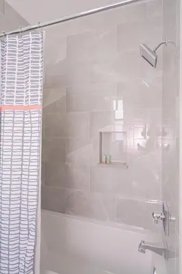 a bathroom with a shower with a glass door at Brand New, Steps To Beach, Gulf Views, Heated Pool in Panama City Beach