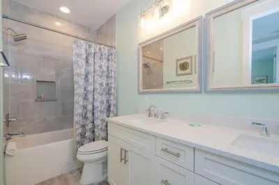 a bathroom with a sink and a toilet and a shower at Brand New, Steps To Beach, Gulf Views, Heated Pool in Panama City Beach