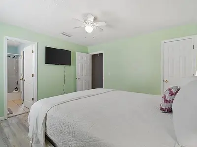 a bedroom with a bed and a ceiling fan at High Tides by Emerald Coast Retreats in Panama City Beach