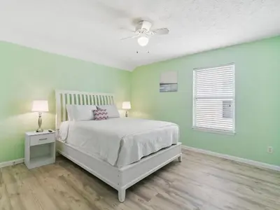 a bedroom with a bed and a ceiling fan at High Tides by Emerald Coast Retreats in Panama City Beach