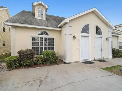 a house with white doors and a driveway at High Tides by Emerald Coast Retreats in Panama City Beach