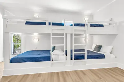 a white room with bunk beds in it at Brand New, Private Pool, Walk To Beach, Game Room in Inlet Beach