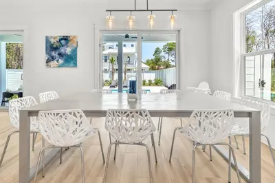 a white dining room with a table and chairs at Brand New, Private Pool, Walk To Beach, Game Room in Inlet Beach