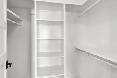 an empty closet with white shelves in a room at Brand New, Private Pool, Walk To Beach, Game Room in Inlet Beach